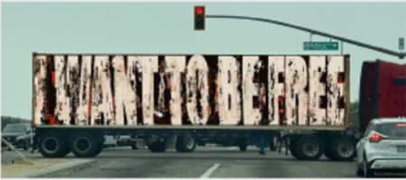 image of a semi struck with the message 'I Want To be Free' Stenciled on its side