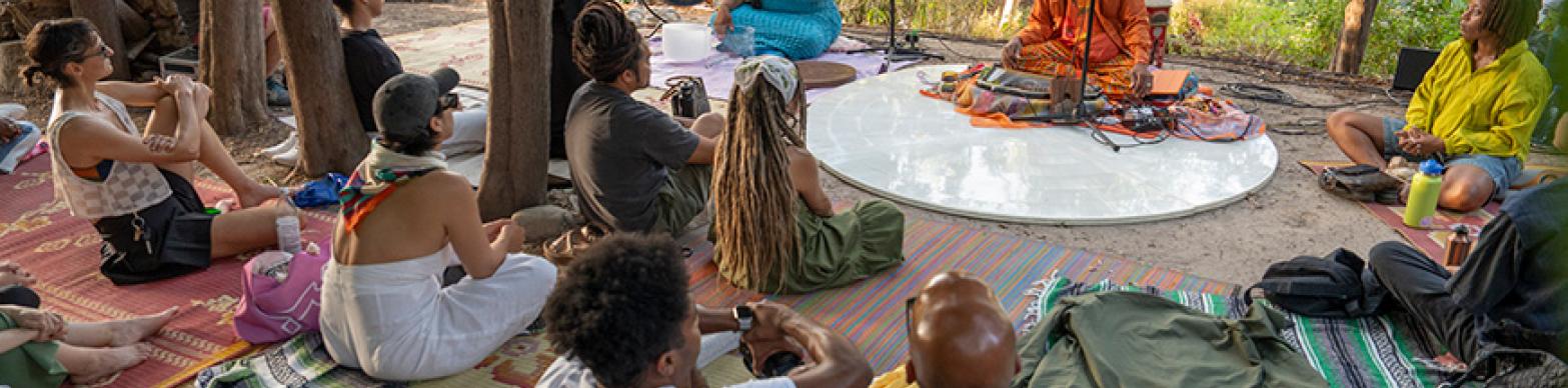 Image of people participating ina performance in the woods
