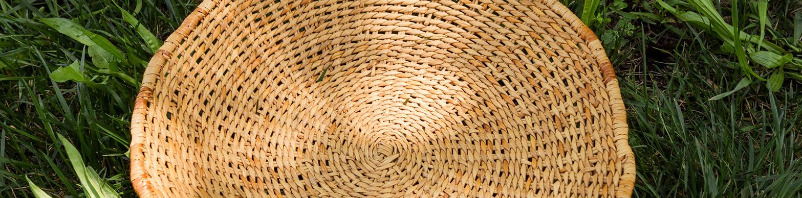Image of a woven basket on a field of green grass