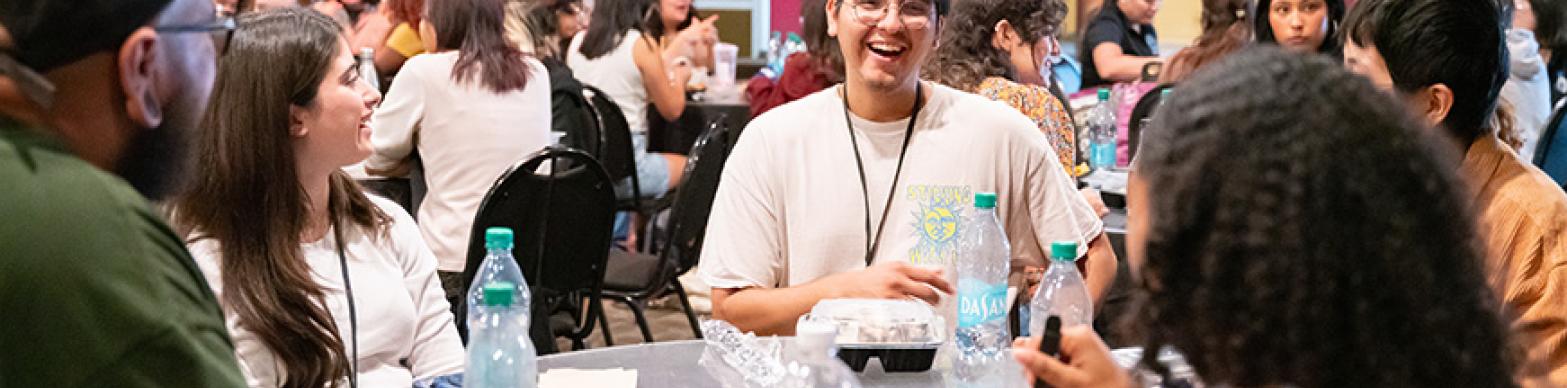 students laughing in a lunch setting