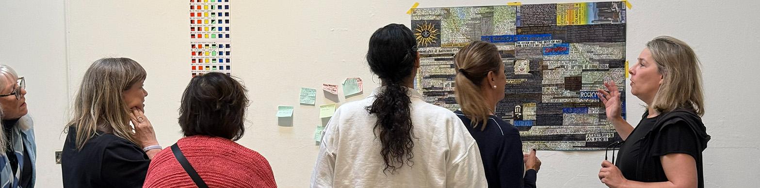 woman leads tour in gallery setting