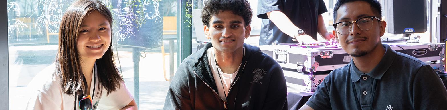 Three interns smile for the camera