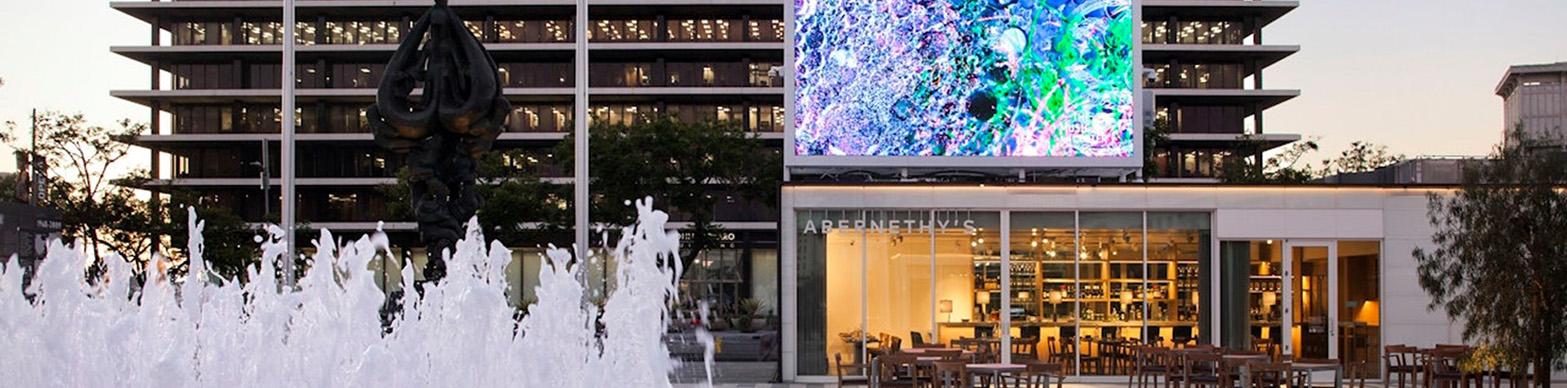 Fountain on public plaza with large scale video isntallation