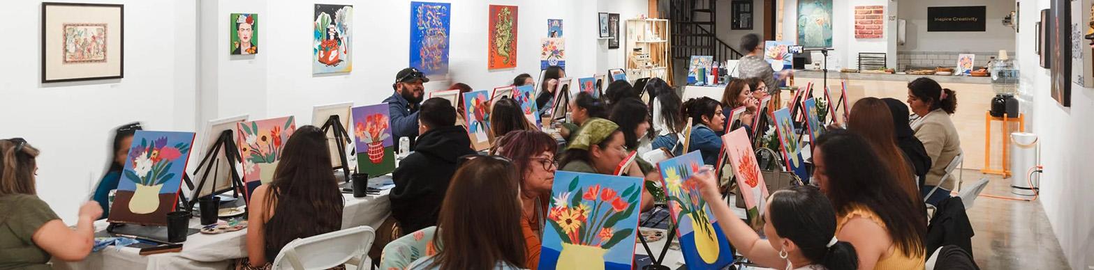 Individuals take part in a group painting activity