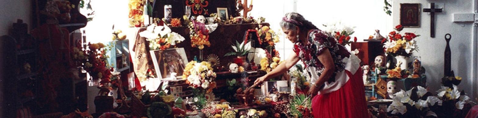 Woman tends to elaborate ofrenda