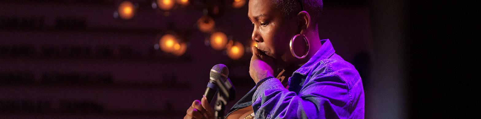 Black woman speaking into a microphone