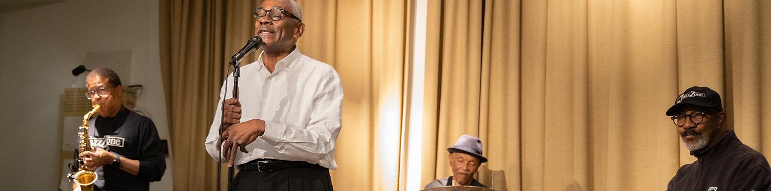 Four black senior men perform as part of a jazz quartet