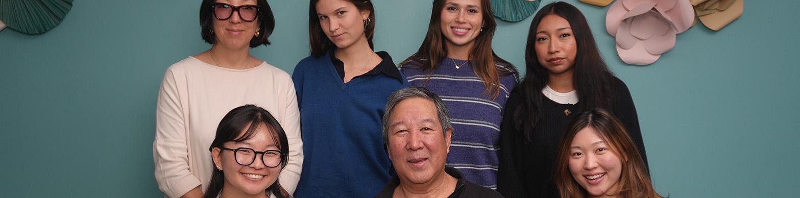 seven individuals pose for a photo