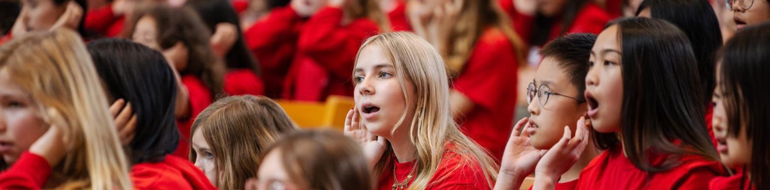 Children sing in red shirts