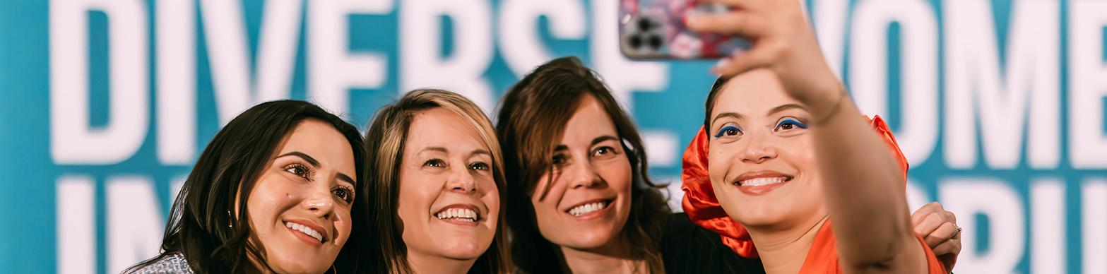 Four women pose for a selfie