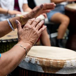 Image of the hands of a black woman drumming